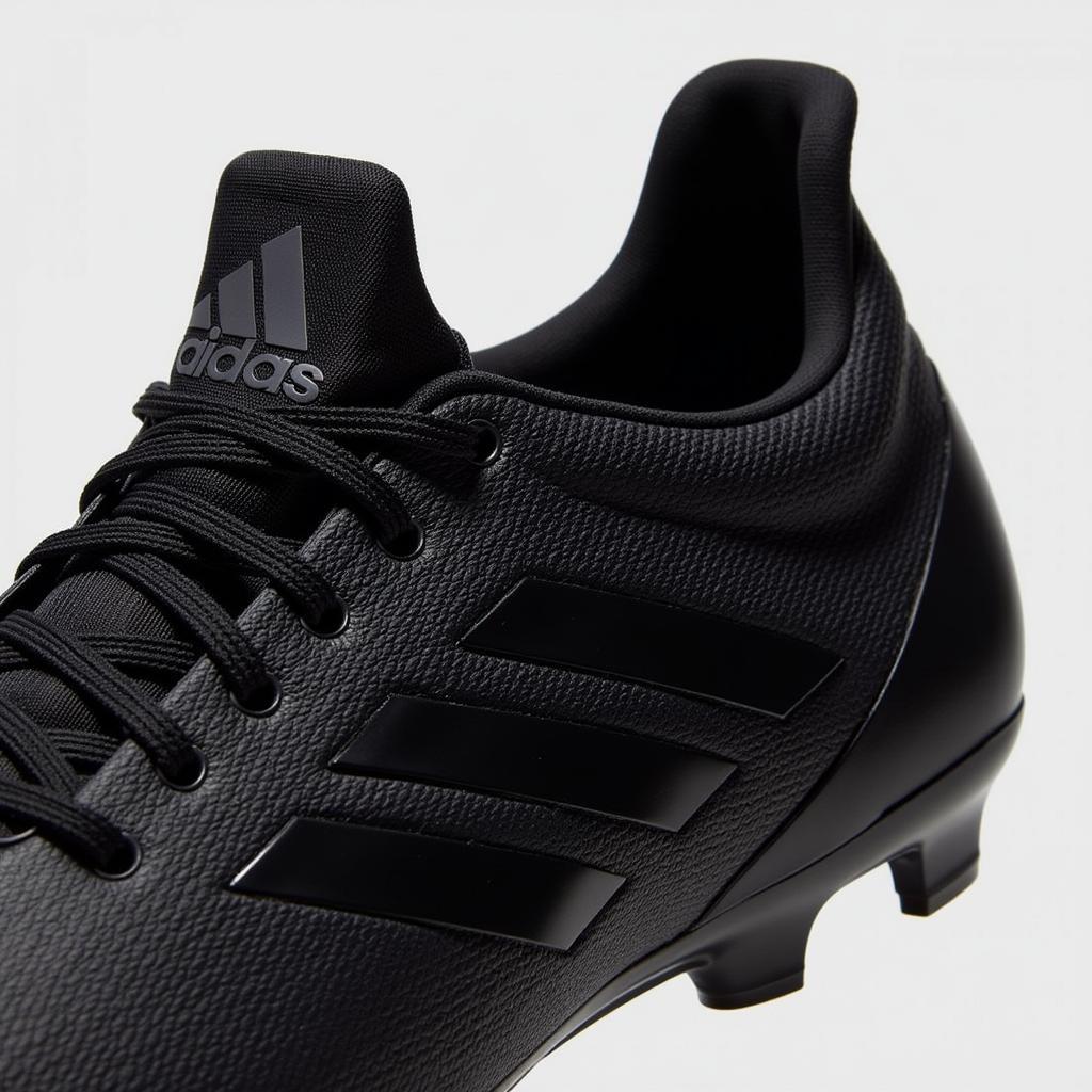 Yamal's Apex 21 Black cleats close-up, highlighting the sleek design and innovative technology.