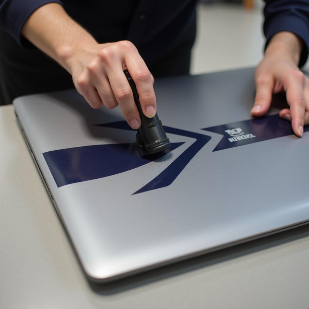 Applying a Yamal livery decal on a laptop