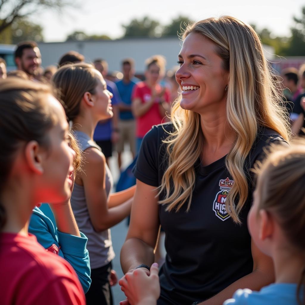 Courtney Petersen interacts with young fans at a community event