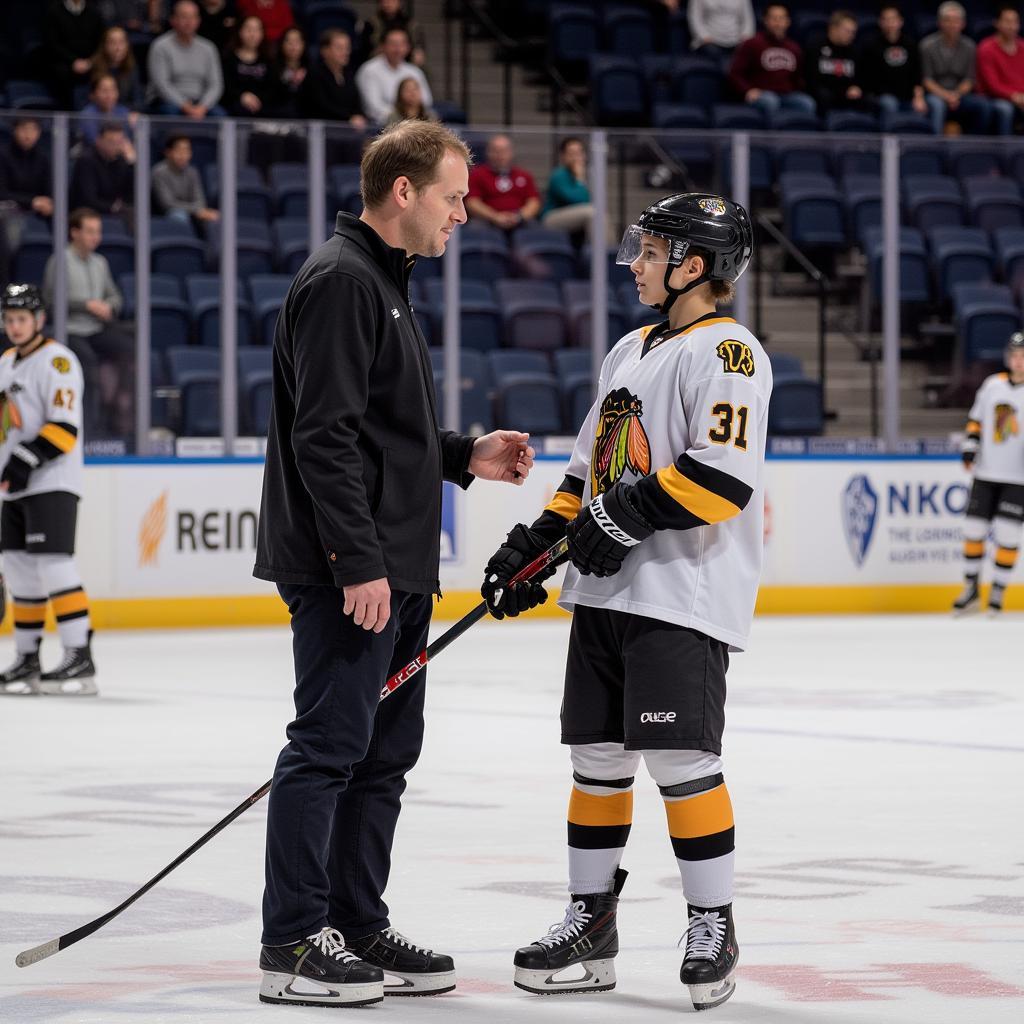 NAHL coach providing one-on-one mentorship to a young player