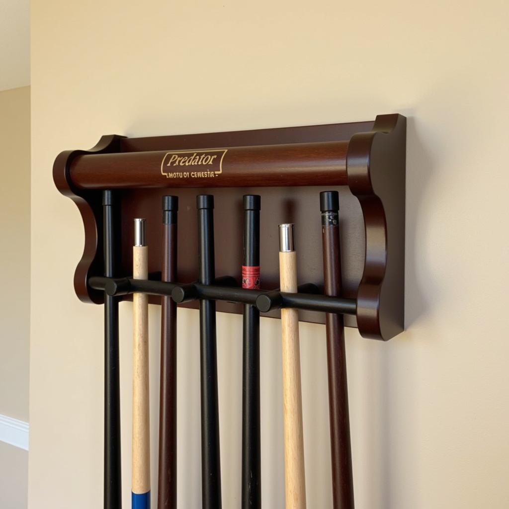 Wall-mounted predator pool rack with sleek design holding several pool cues.