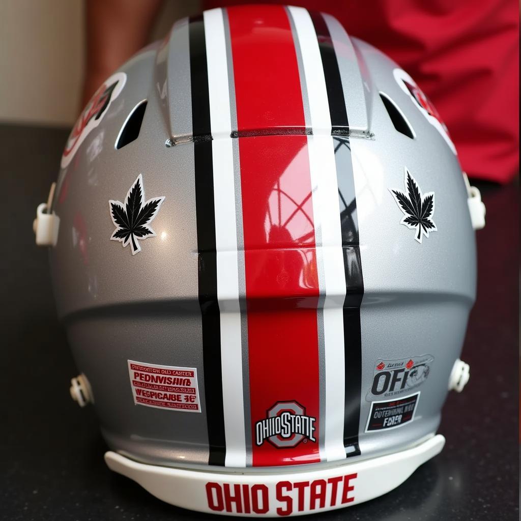 Close-up view of an authentic Ohio State football helmet showcasing the iconic Buckeye leaf stickers and the silver stripe down the middle.