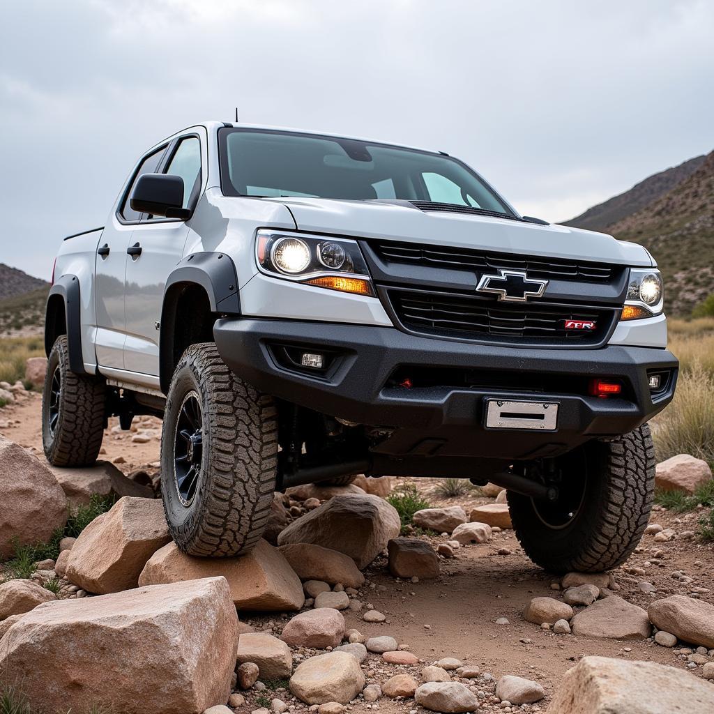 Chevy Colorado ZR2 with aftermarket front bumper navigating a rocky off-road trail