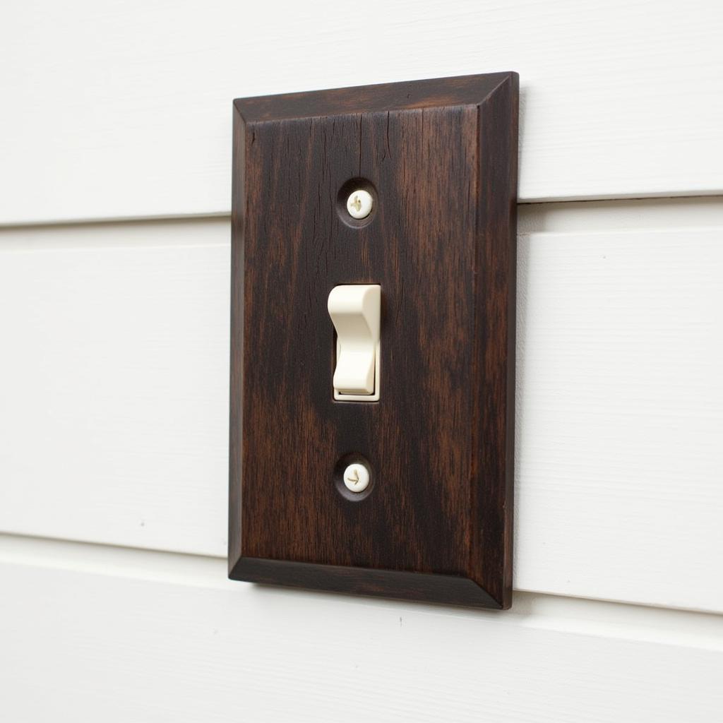 Rustic wood light switch cover on a shiplap wall