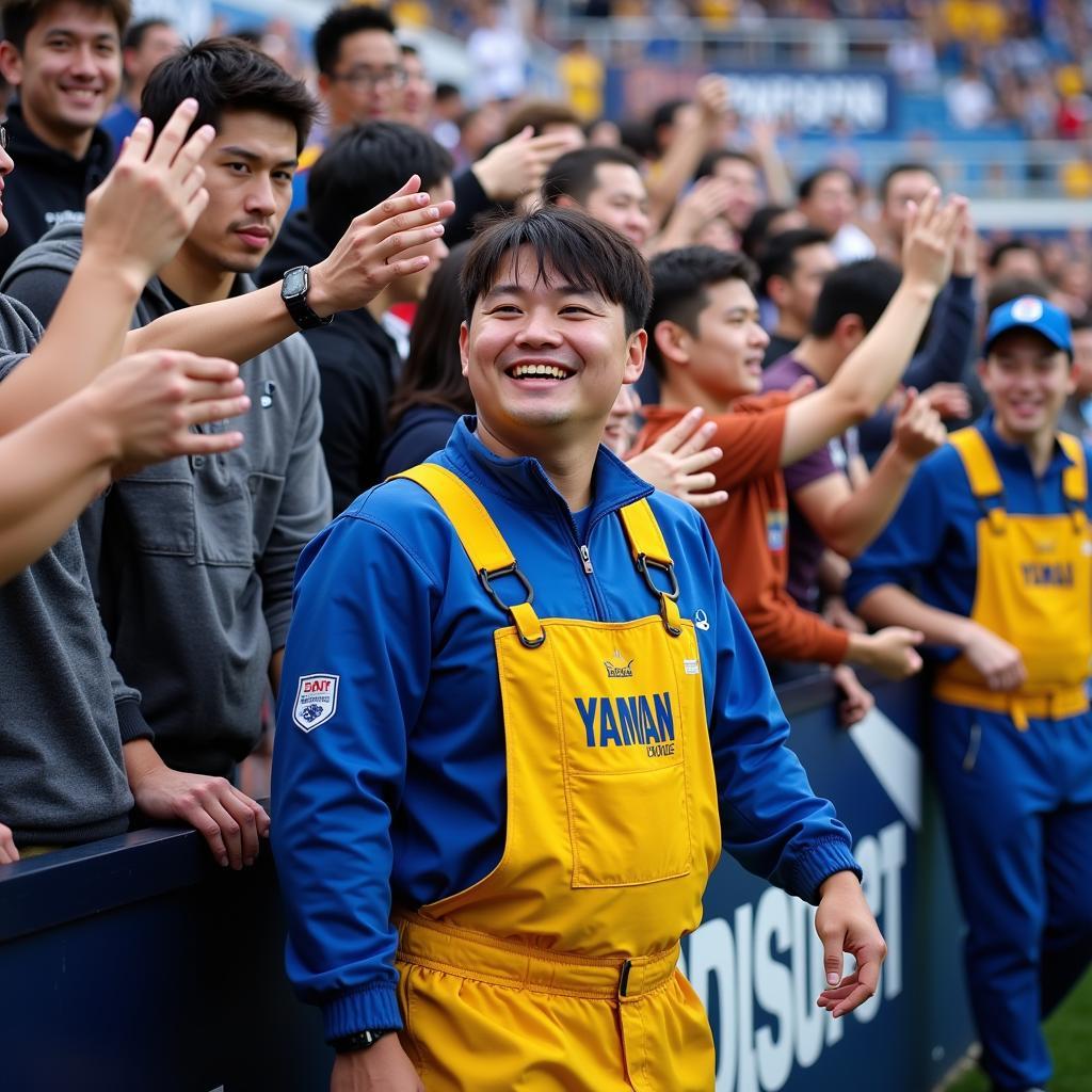 Yamal wearing blue and gold overalls while interacting with fans.