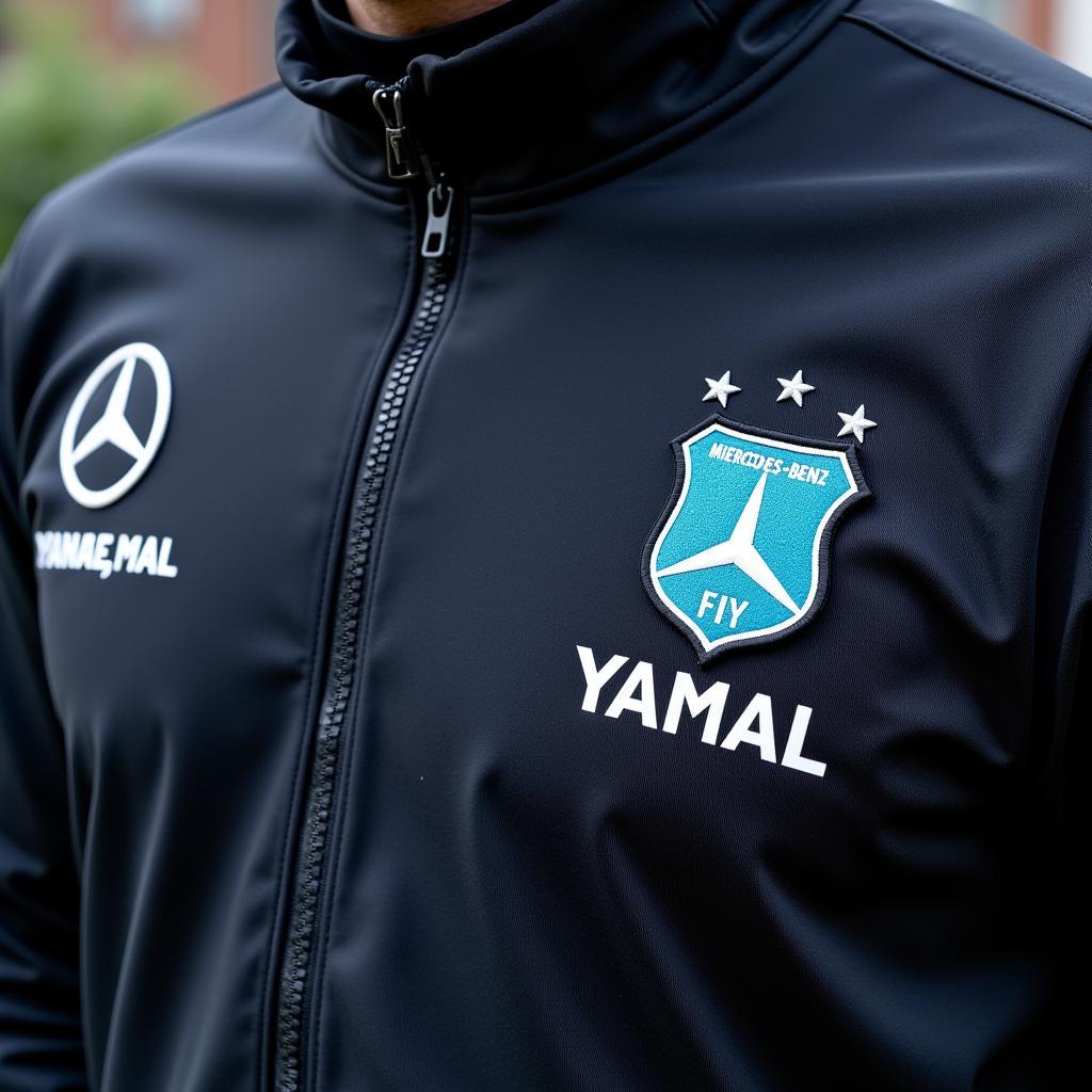 Close-up view of the Mercedes-Benz patch on Lamine Yamal's training jersey.