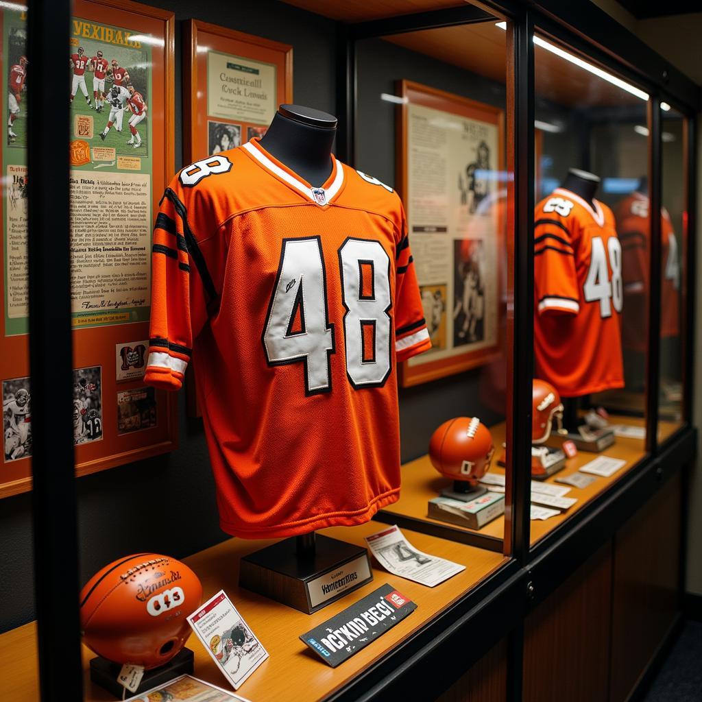 A display case filled with Bengals memorabilia including jerseys, helmets, and signed footballs.