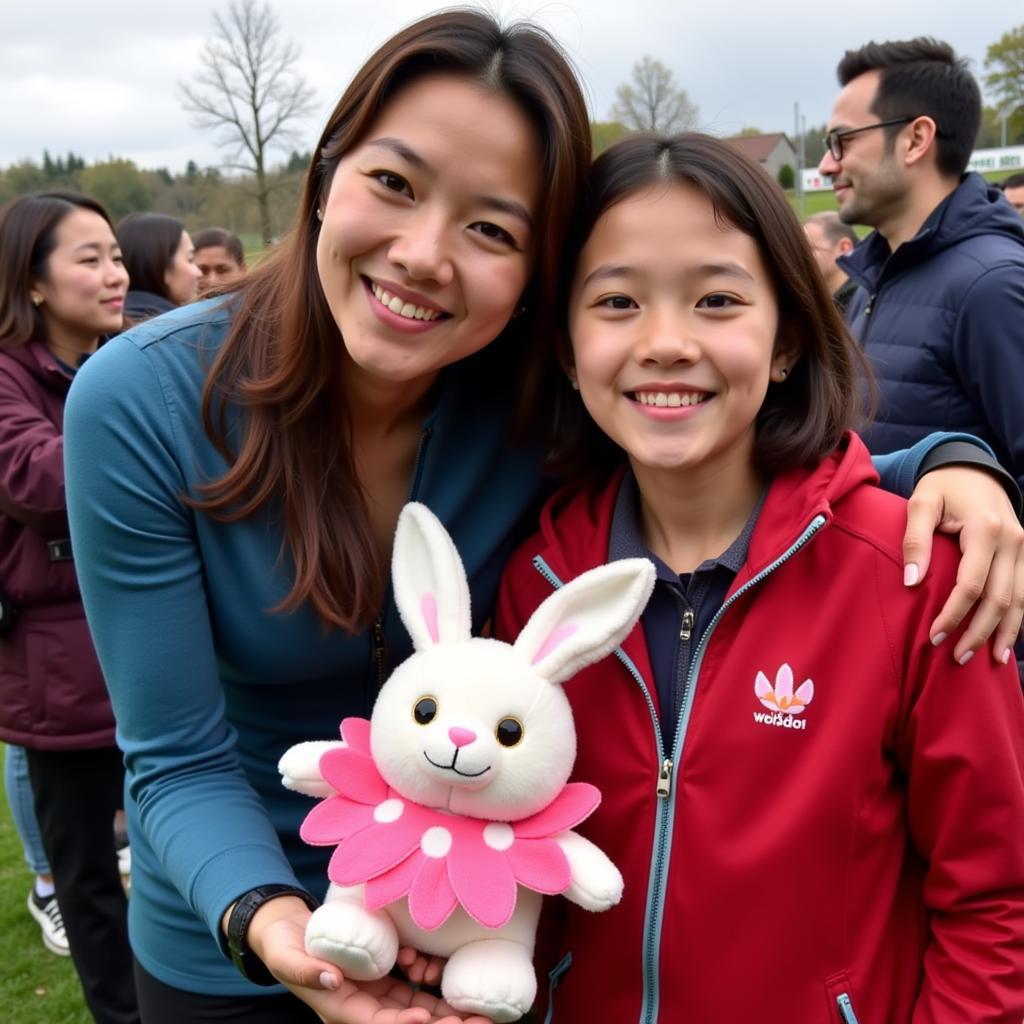 Yamal Interacting with a Fan Holding a Flower Bunny Toy